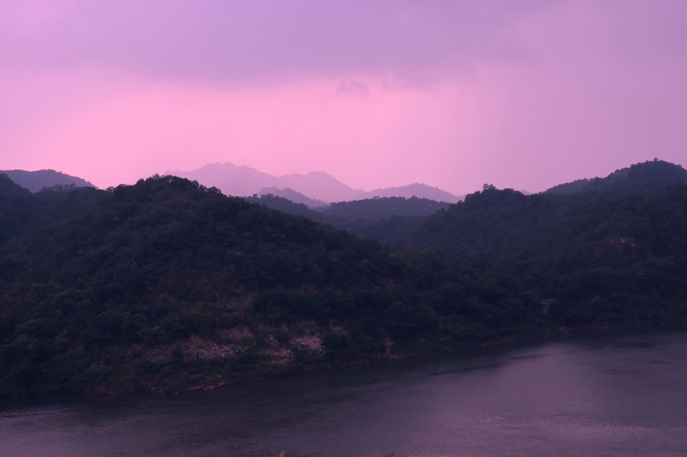 Purple-hour hills over a river